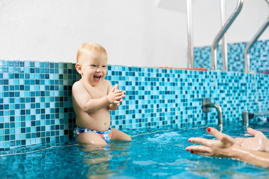 Baby having fun in the swimming pool